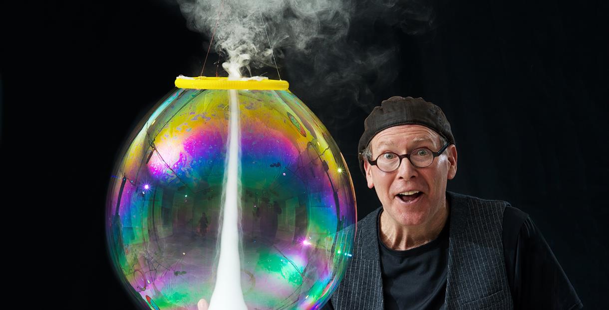 A man holding a giant bubble