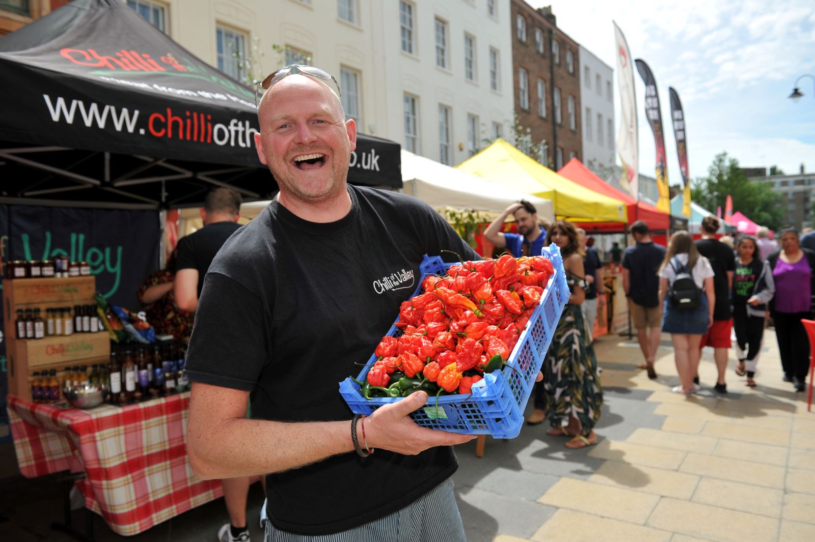 Stallholder holding chillies