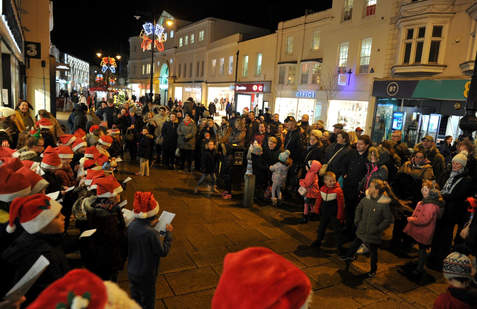 Carol singers on Cheltenham High Street during a busy late night shopping evening