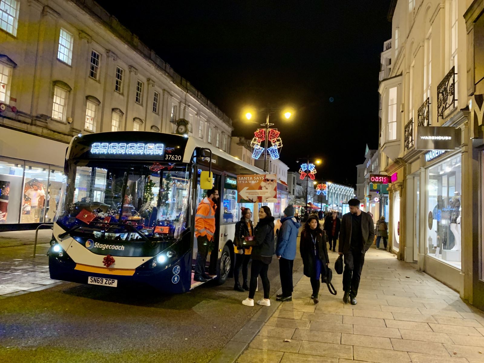 Customers about the board Christmas themes Stagecoach bus