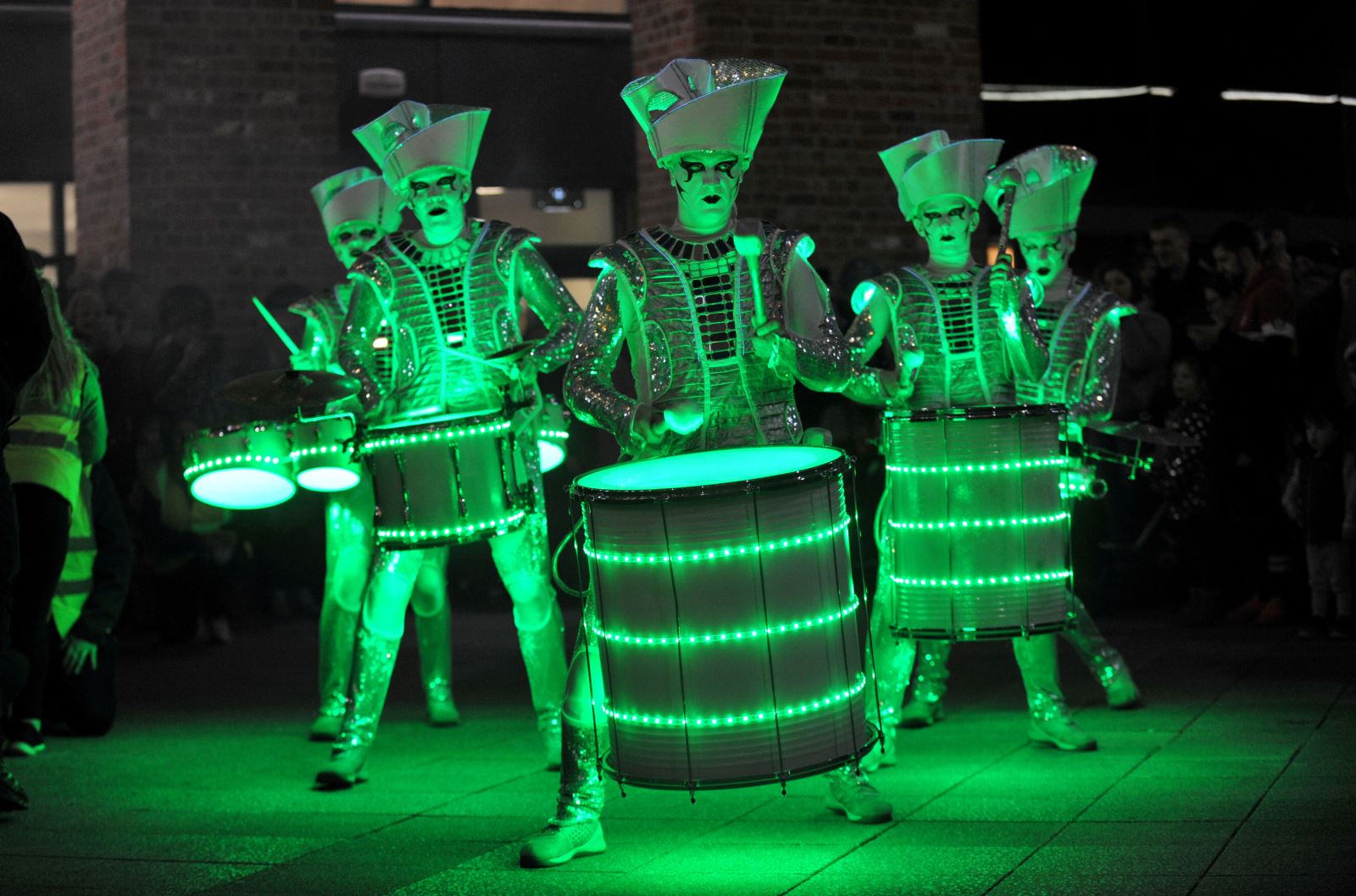 Spark! performers lit up in green in Cheltenham