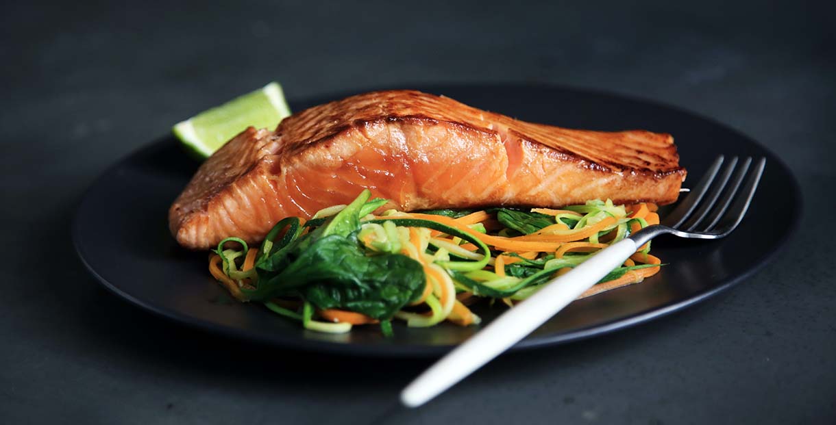 Baked salmon on a bed of shredded cucumber and carrot