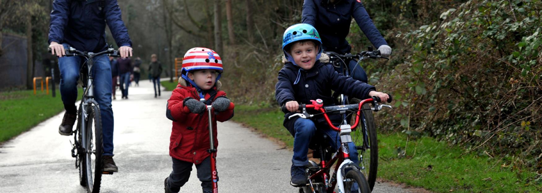 Family cycling and scooting along the Honeybourne Line in Cheltenham