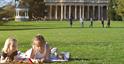 Two young children lying on a picnic blanket with Pittville Pump Room in the background