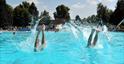 Two people dive into the outdoor pool at Sandford Park Lido in Cheltenham