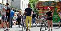 Young couple walking with the cycles through Cheltenham