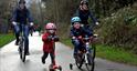 Family cycling and scooting along the Honeybourne Line in Cheltenham