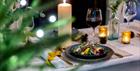 Set dining table with candles and Christmas decorations.