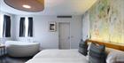 Large bedroom with bath in room at Malmaison Cheltenham