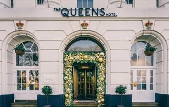Queens Hotel exterior with Christmas decorated entrance