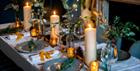 Set dining table with candles and Christmas decorations.
